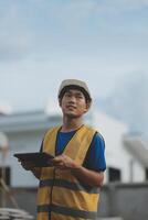 worker inspection while in Left hand hold tablet. inspector engineer using tablet. photo