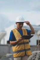 worker inspection while in Left hand hold tablet. inspector engineer using tablet. photo