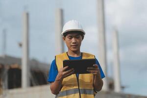 worker inspection while in Left hand hold tablet. inspector engineer using tablet. photo