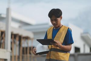 worker inspection while in Left hand hold tablet. inspector engineer using tablet. photo
