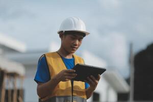 worker inspection while in Left hand hold tablet. inspector engineer using tablet. photo