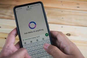 Smartphone Displaying Meta AI Chat Application With User Typing on the Keyboard photo