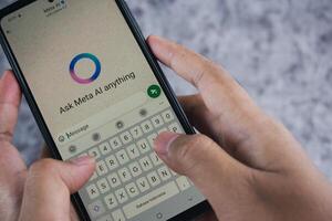 Smartphone Displaying Meta AI Chat Application With User Typing on the Keyboard photo