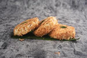 Indonesian Traditional Coconut Cake called Sagon on Banana Leaf with Rustic Background Setting photo