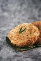 Indonesian Traditional Coconut Cake called Sagon on Banana Leaf with Rustic Background Setting photo