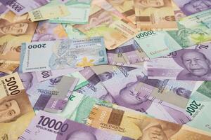 Various Colorful Indonesian Rupiah Banknotes Displayed in a Scattered Arrangement photo