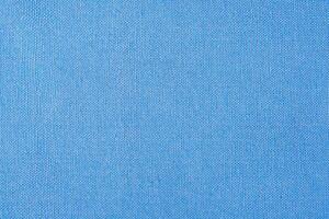 Light blue fabric as a background macro photo. Blue background photo