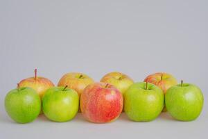 Green and red apples on a gray background. Fruits, apples photo