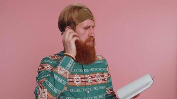 Thoughtful journalist man making notes, writing down thoughts with pen into notepad notebook diary video