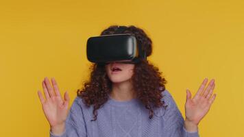 Young woman using virtual reality headset helmet to play simulation game app, watching content video