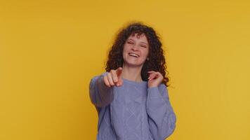 Amused smiling curly haired woman pointing finger to camera, laughing out loud funny joke anecdote video