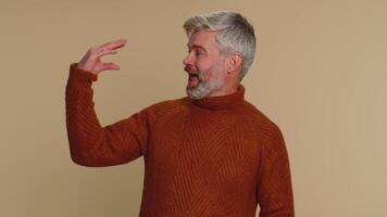 Middle-aged mature old man showing bla-bla-bla nonsense gesture with hands, gossips, empty promises video