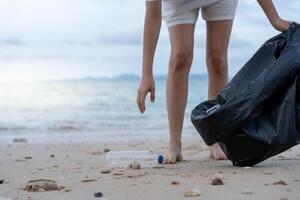 Save water. Volunteer pick up trash garbage at the beach and plastic bottles are difficult decompose prevent harm aquatic life. Earth, Environment, Greening planet, reduce global warming, Save world photo