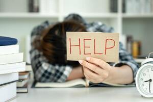 Asian student woman have anxiety because of exams, female prepare for test and learning lessons in the library. stress, despair, haste, misunderstanding reading, discouraged, expectation, knowledge photo