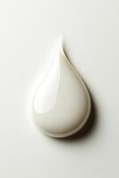 Top view of a drop of white cream on white background photo