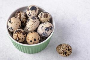 A dish with quail eggs placed on a textured surface. Concept of healthy eating photo