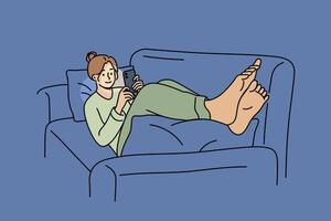 Women lie on sofa with mobile phone in hands and play games or watch videos on social networks vector