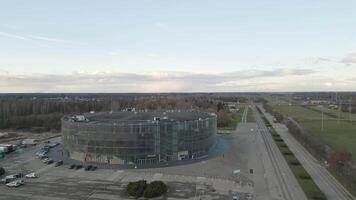 Siauliai, Lithuania - 12th november, 2024- aerial view Siauliai arena panorama with city buildings outside in sunny autumn day. Hosts basketball games, concerts and shows video