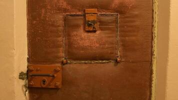 Vilnius, Lithuania - 30th november, 2024 - The former KGB prison. Corridor with cells. Museum of Occupations and Freedom Fights. Old soviet door in prison display video