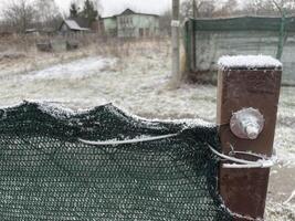 Snow resting gently on a garden fence photo