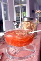 Es blewah is a refreshing drink that is popular in Indonesia, made from grated cantaloupe, syrup, ice cubes, condensed milk, and other ingredients. photo