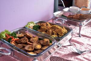 Chicken satay, chicken spicy and balado eggs served in a buffet lunch. A concept of self-service catering menu for small parties. photo