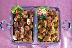 Flat lay view of chicken spicy and balado eggs served in a buffet lunch. A concept of self-service catering menu for small parties. photo