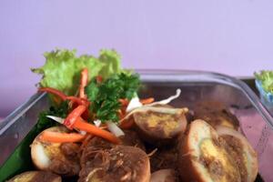 Closeup view of delicious balado eggs served in a buffet lunch. A concept of self-service catering menu for small parties. photo