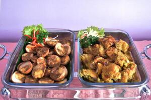 High angle view of chicken spicy and balado eggs served in a buffet lunch. A concept of self-service catering menu for small parties. photo