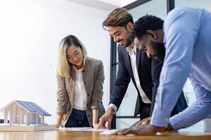 Team of architectures and businessmen discussing and brainstorming on floor plan modification for real estate investment and housing development concept photo