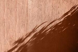 Mocha Mousse - color of the year 2025. terracotta background with shadow overlay photo