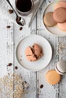 Mocha Mousse - color of the year 2025. Flat lay macarons on the wooden table with coffee photo