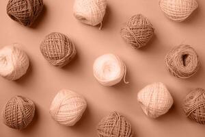 Mocha Mousse - color of the year 2025. yarn wool on brown backdrop, top view flat lay photo