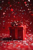 red gift box on red background with bright falling confetti. photo