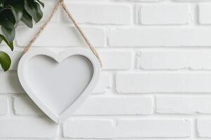 Photo frame of heart shape for mockup design on light wall background.