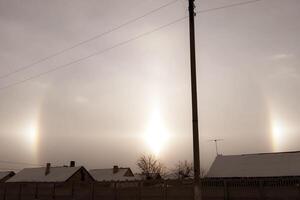 phenomenon of halo in the sky. A rare natural phenomenon. Three halo suns. photo