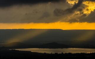 Dawn in the mountains of Crimea. light haze of mist over the mountains and rays of the sun through the clouds. photo