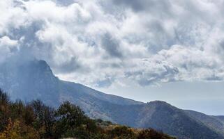 Mountains and forests of Crimea. coniferous and deciduous trees on the hills of mountains and rocks photo