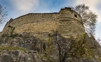 old limestone house on a cliff on the edge of a cliff. photo