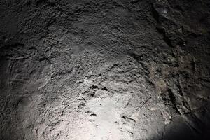 An Intimate CloseUp of a Textured Rock Surface Captured in Low Light Conditions photo