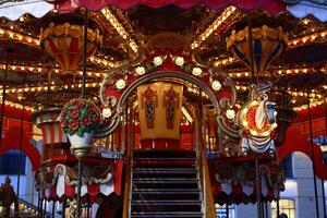 Experience the enchanting and charming carousel adorned with vibrant lights and beautiful decor photo