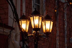 Illuminated street lanterns create an enchanting atmosphere, enhancing the citys charm at night photo