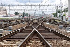 The captivating view of railroad tracks converging at a bustling and busy train junction photo