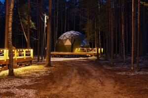 A Serene Dome Structure Nestled in a Lush Forest During the Beautiful Twilight Hours photo