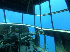 A stunning and enchanting underwater view showcasing a shipwreck cockpit full of secrets photo