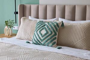 An Elegant Bedroom Featuring Textured Pillows and a Soft and Inviting Color Palette photo