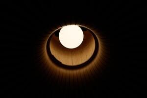 A Beautifully Illuminated Circular Opening Creating a Contrast in an Expansive Dark Space photo