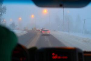 A Foggy Winter Drive Engaging Evening Commute in Challenging Snowy Conditions Ahead photo