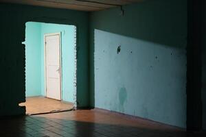 A mysterious doorway is set within a soft blue room, which is bathed in gentle light and serenity photo