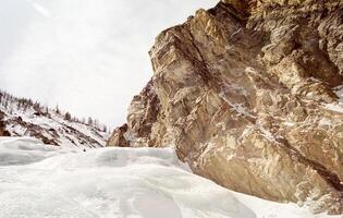 Mount Sayan in winter in snow. The nature of the mountains is sayan. photo